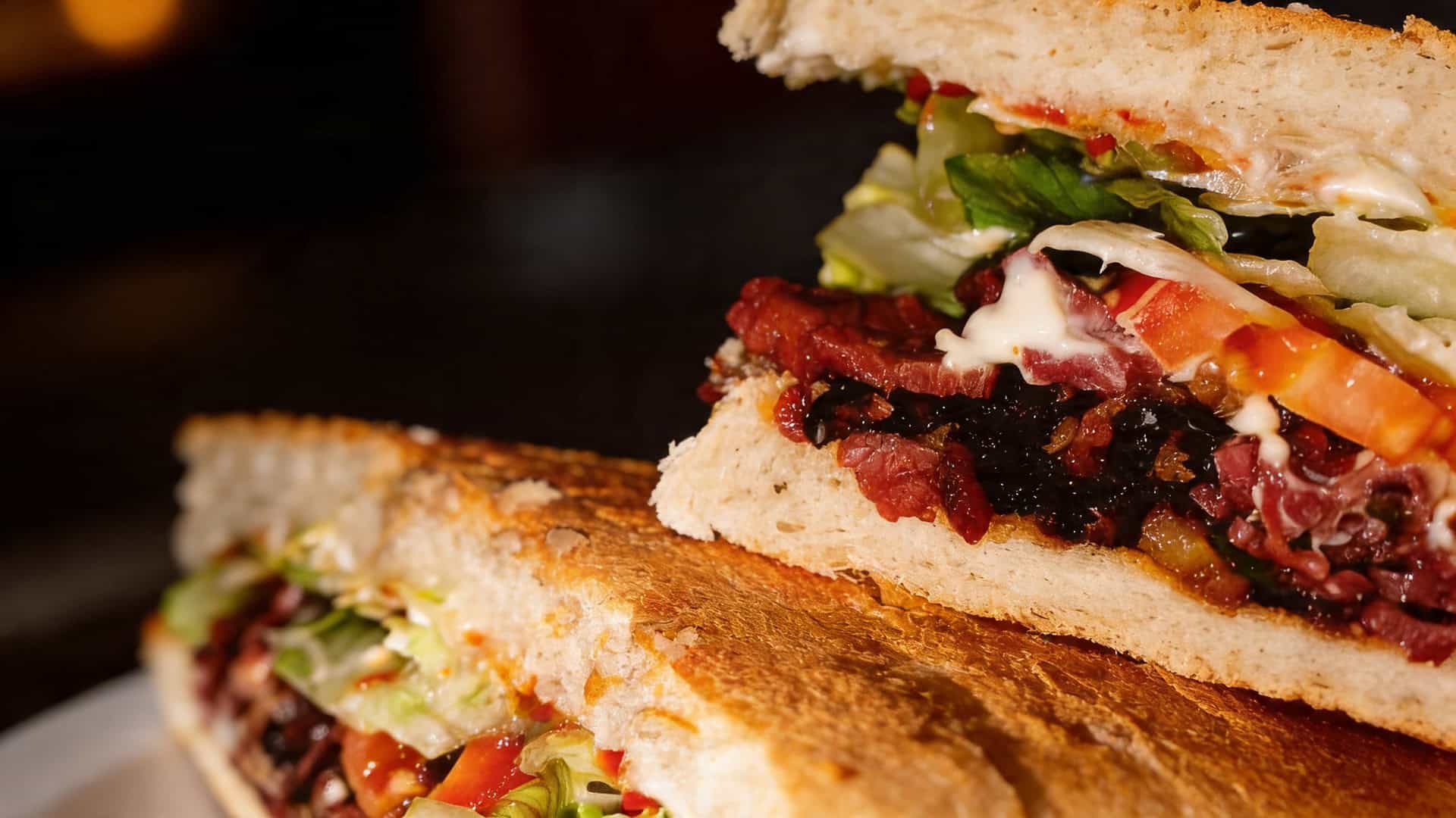 Detail of toasted bread and generous Puerto Rican sandwich fillings